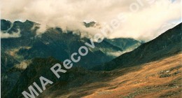 Crash site on grassy slope in background