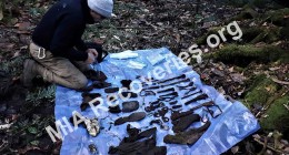 Clayton examining personal artifacts and tools