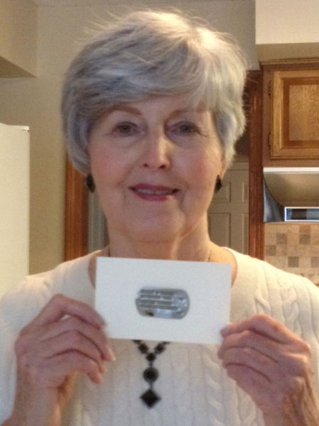 Betty Sue (Atchley) Brown, niece of SSgt. Harry D. Tucker, holding his recovered ID tag