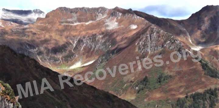 Crash site on green slope in rear-center