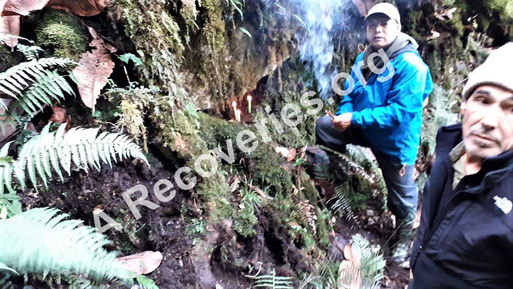 Lighting prayer candles and<br /> incense sticks at crash site<br /> before starting excavation