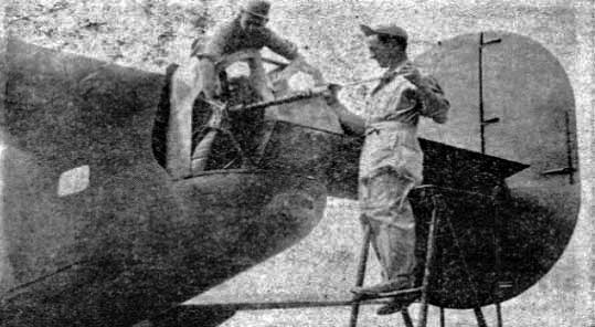 Flight Engineer SSgt. Charles D. Ginn cleaning gun