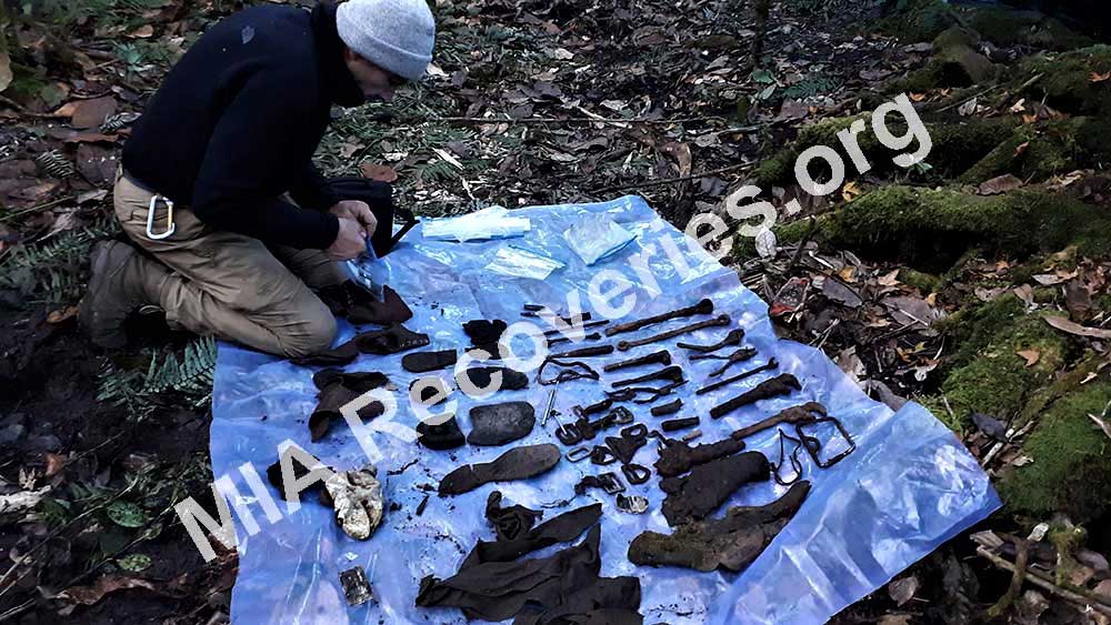 Clayton examining personal artifacts and tools